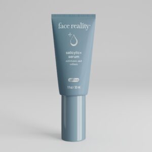 Grey blue one ounce bottle of Face Reality salicylic+ serum product with acne-safe stamp on bottle standing alone on a light grey background.